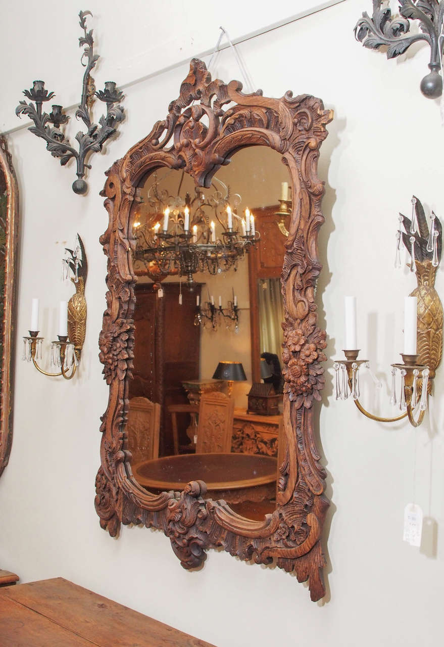 Antique French bois naturel carved chestnut mirror.