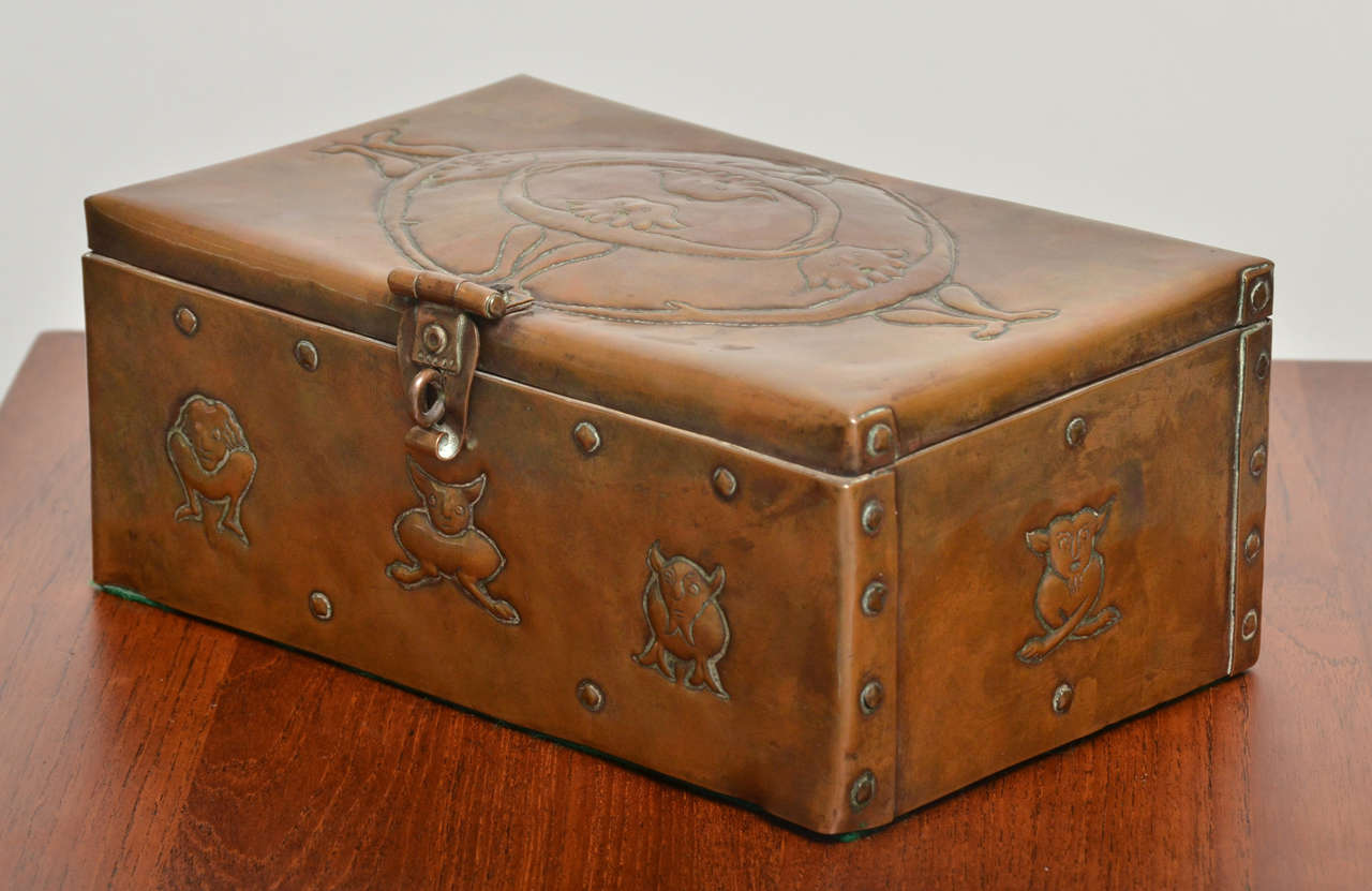 Documented John Pearson Copper Box with hinged lid and hasp.  Relief ornament on all sides and lid, a host of hybrid beasties.  Suitable storage for vices.