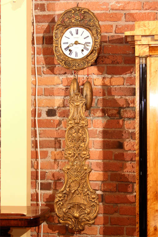 French Morbier Bronze and Painted Wall Clock. 

This signed clock was made by Caingnard Fils from A St. Sever France. As far as we know it has never had a wood case because they gilded the weights because they were exposed. This clock runs for