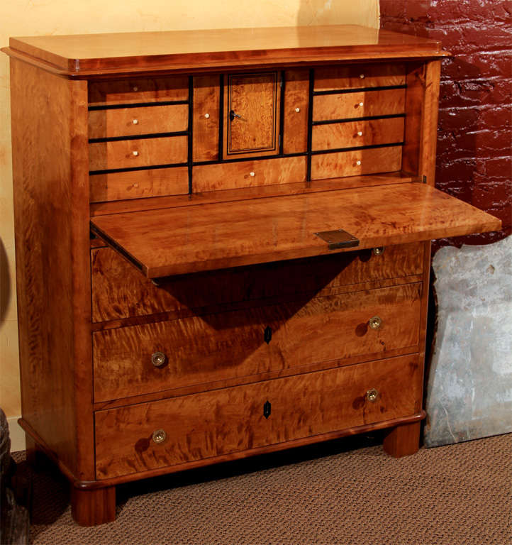 Swedish Biedermeier Secretaire

This Swedish fall front secretaire features highly figured birch veneer on the front. It has a drop front desk over three long drawers. 

The interior of the fall front has eleven original dove-tailed drawers with