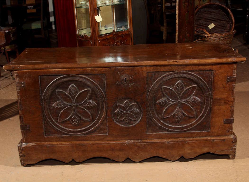 18th Century French Coffer

This is a solid oak coffer with one board top.  It features a dove-tailed case with the original lifting handles on the sides. The dove-tailed case is reinforced with eight iron straps.

The front has lovely