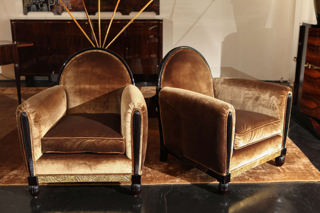 Pair of beautiful salon chairs attributed to Maurice Dufrene. Dark Brown Lacquer with gold leaf floral relief detail on bottom of frame. Upholstered in silk velvet.