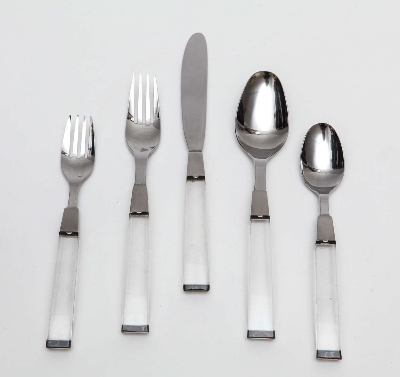 A fantastic set of Lucite handled stainless steel flatware that includes full service for sixteen that is in very good condition. There are a total of 257 pieces, some of which show crazing to the handles, which creates a interesting contrast to the