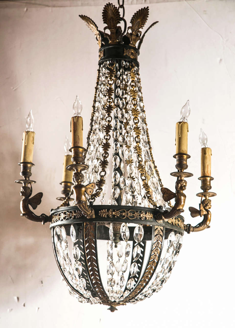 Antique French 6 light gilded and patinated chandelier. Strands of  graduated lozenge  shaped crystals. bands of  patinated  bronze mounted with gilt bronze decorative  devices, surmounted by  6 gilt bronze anthemions.  from the central  band extend