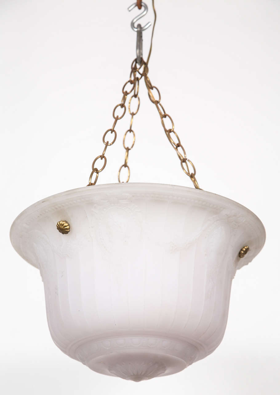 Here is a heavy cast glass dish light with original chain. There are delicate wreaths which give it a slightly formal look. 
Please note, this item is located in our Los Angeles location.
