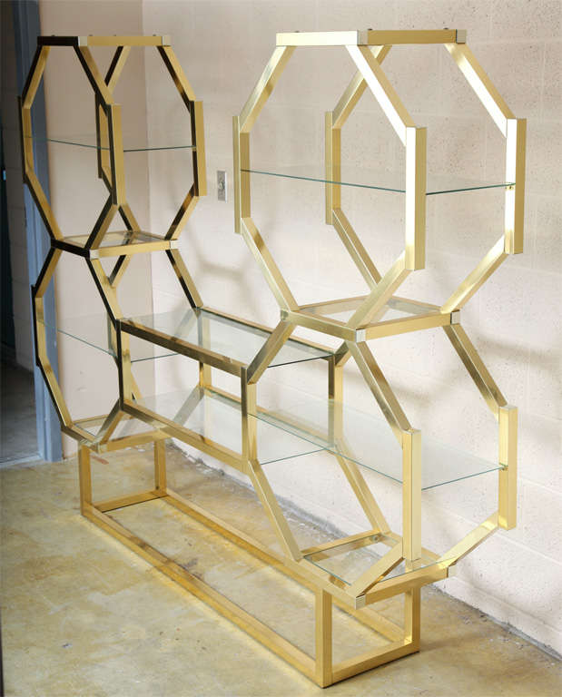 Fabulous  Brass Etagere or Display Cabinet featuring 
the unusual octagonal design with inset glass shelves.
This one of a kind piece can be used as a free standing space divider.