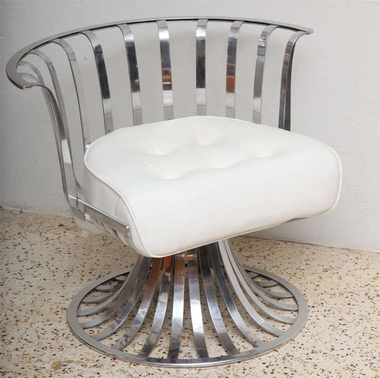 Super-sexy, slatted aluminum chairs designed by Russell Woodard are perfect for outdoor use, but equally stunning indoors. We've shown them with their original white vinyl seat cushions (and additional back cushion in Image 8), but we envision them