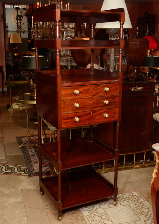 A fine English Regency mahogany five - tier Etagere with three drawers and writing compartment.