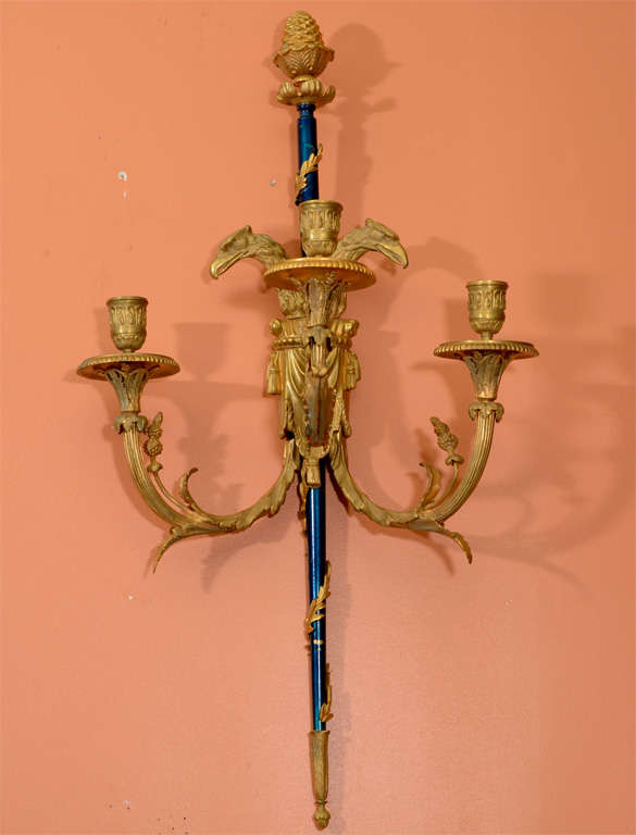 Set of four Louis XVI gilt and cobalt bronze three-arm wall lights with eagles, acorns and acanthus leaves.