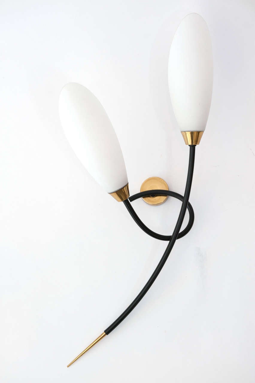 A stylish and graceful pair of French sconces with original white
glass shades.