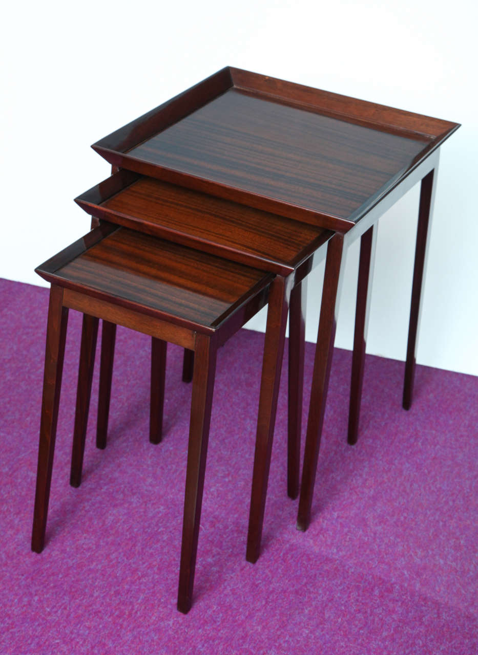 Set of three tables of mahogany with thin tapering legs and gallery edge.   Largest: h. 26