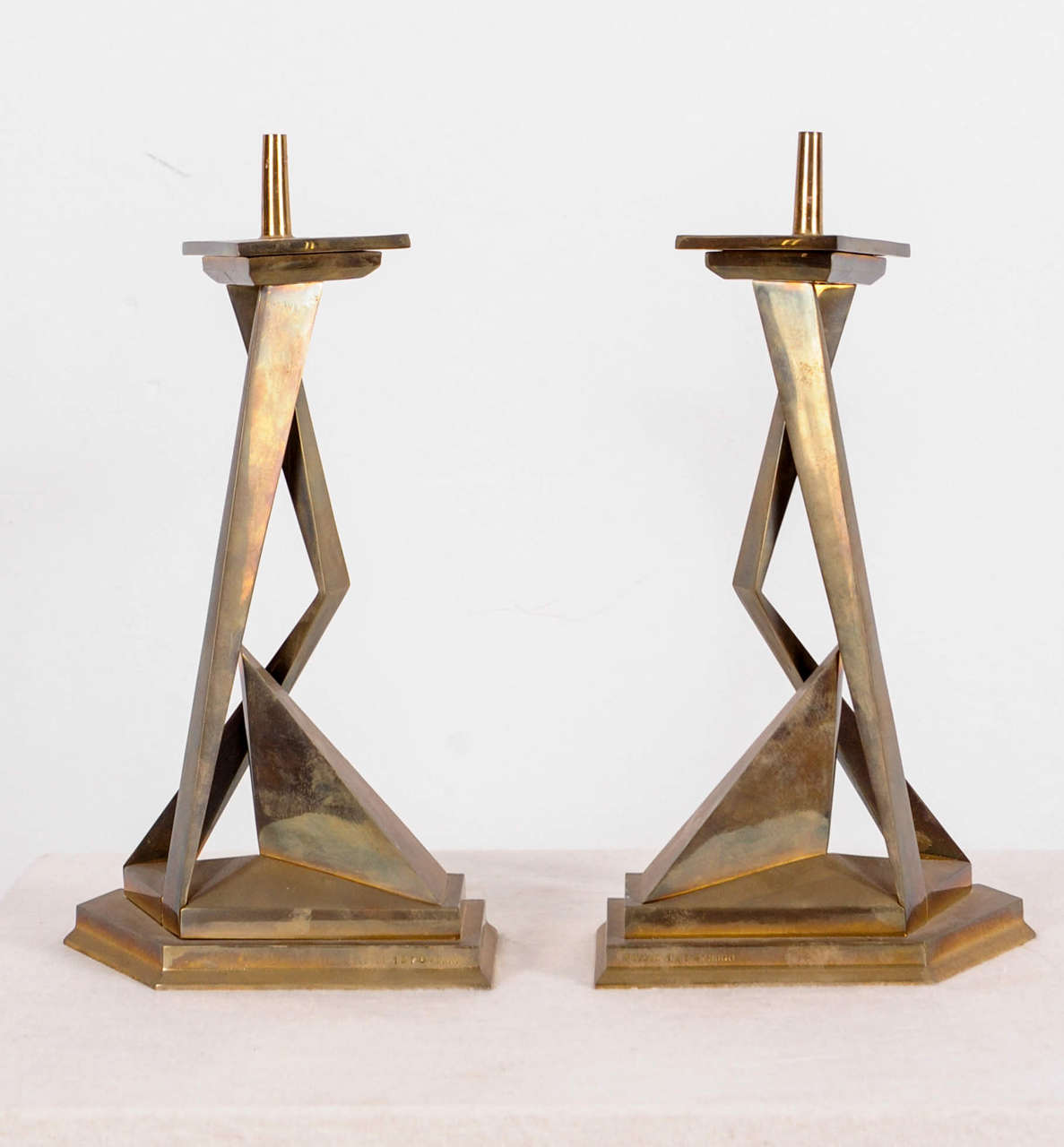 Two bronze candlesticks by Salvador Dali, representing the mythological twin brothers Castor and Pollux. Each candlestick has an interchangeable triangular shaped top insert. The object is signed Salvador Dali (on the edge of the plinth). Castor is