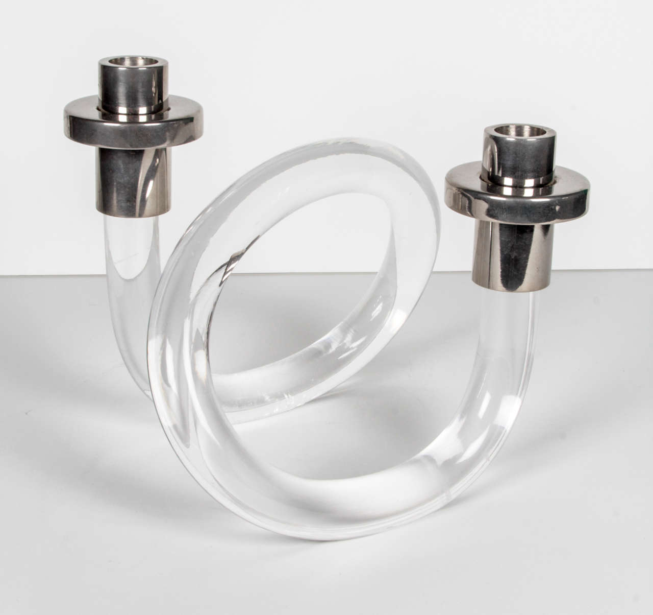 A Dorothy Thorpe 2-arm lucite candle holder with silver-plated fittings.