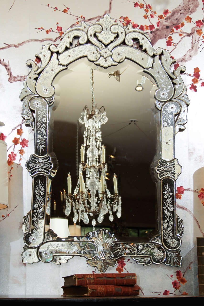 A large 19th century Venetian mirror with cut, beveled and etched glass.