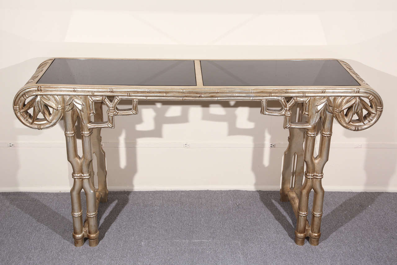 Elegant Bamboo carved console which has a beautiful glazed silver leafed finish by james Mont.
The console has two black inset mirrored tops.