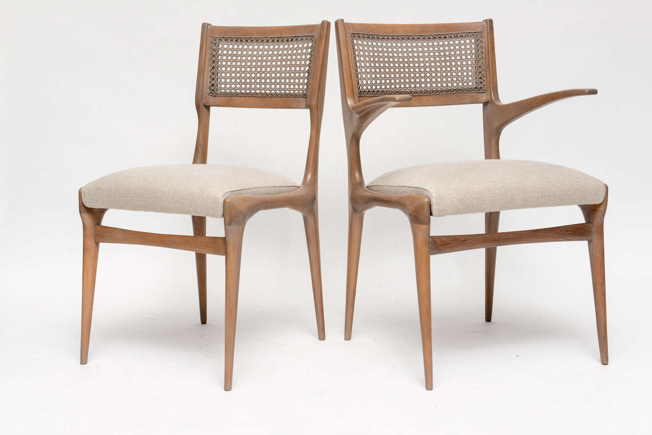 Spectacular set of 50's Italian dining chairs by Carlo di Carli. Bleached European walnut with original hand-caning, we've given them the softest grey wash and pearly, pure linen upholstery. Two armchairs and four side chairs.