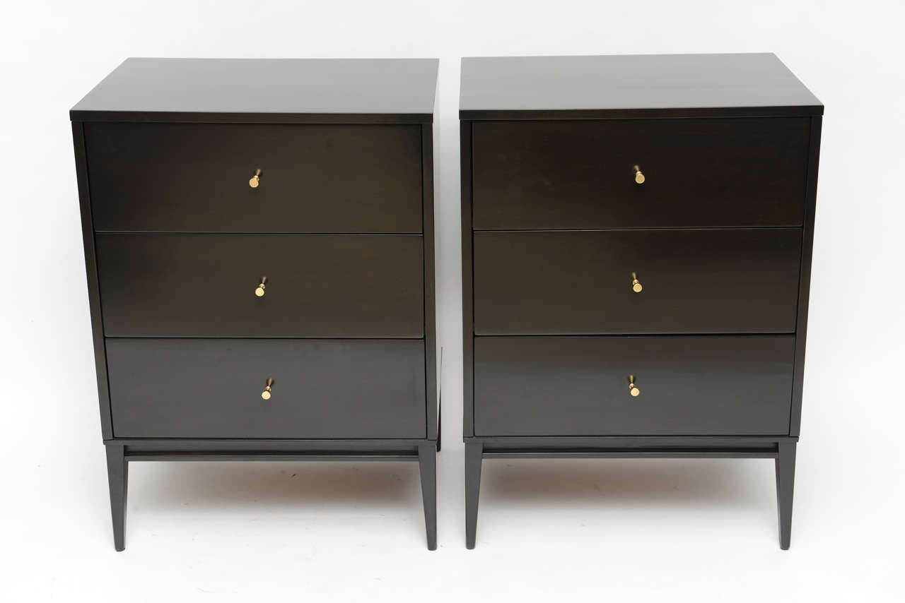 Handsome pair of Paul McCobb ebonized Planner Group 3-drawer chests, with original conical brass pulls. Makes a great pair of tall bedside tables! Completely restored.