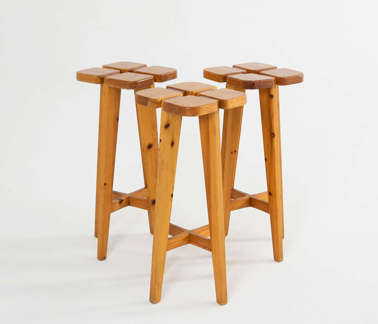 Set of three barstools by Lisa Johansson Pape in solid pine, produced by Stockmann AB, Kervo Woodwork Factory, Helsinki.

These barstools are part of the Scandinavian Mid-Century collection. The seats have a clover-like look and the legs are