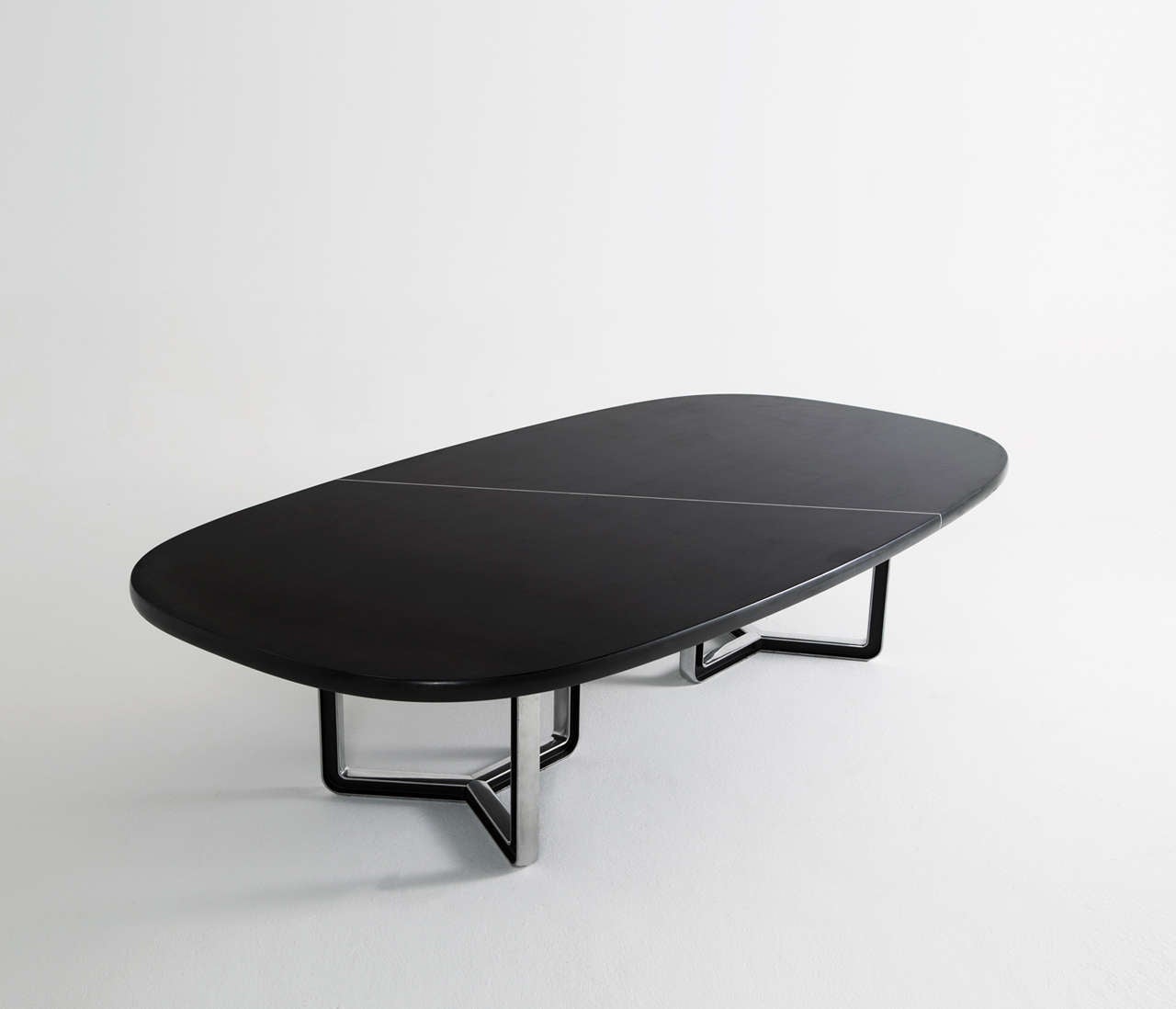Tecno Design Centre for Tecno, lacquered black wood and aluminum base, conference table 335a, Italy, 1975-1978.

Large oversized conference table with a black top. The table is composed of two black pieces connected via steel inserts and mounted on
