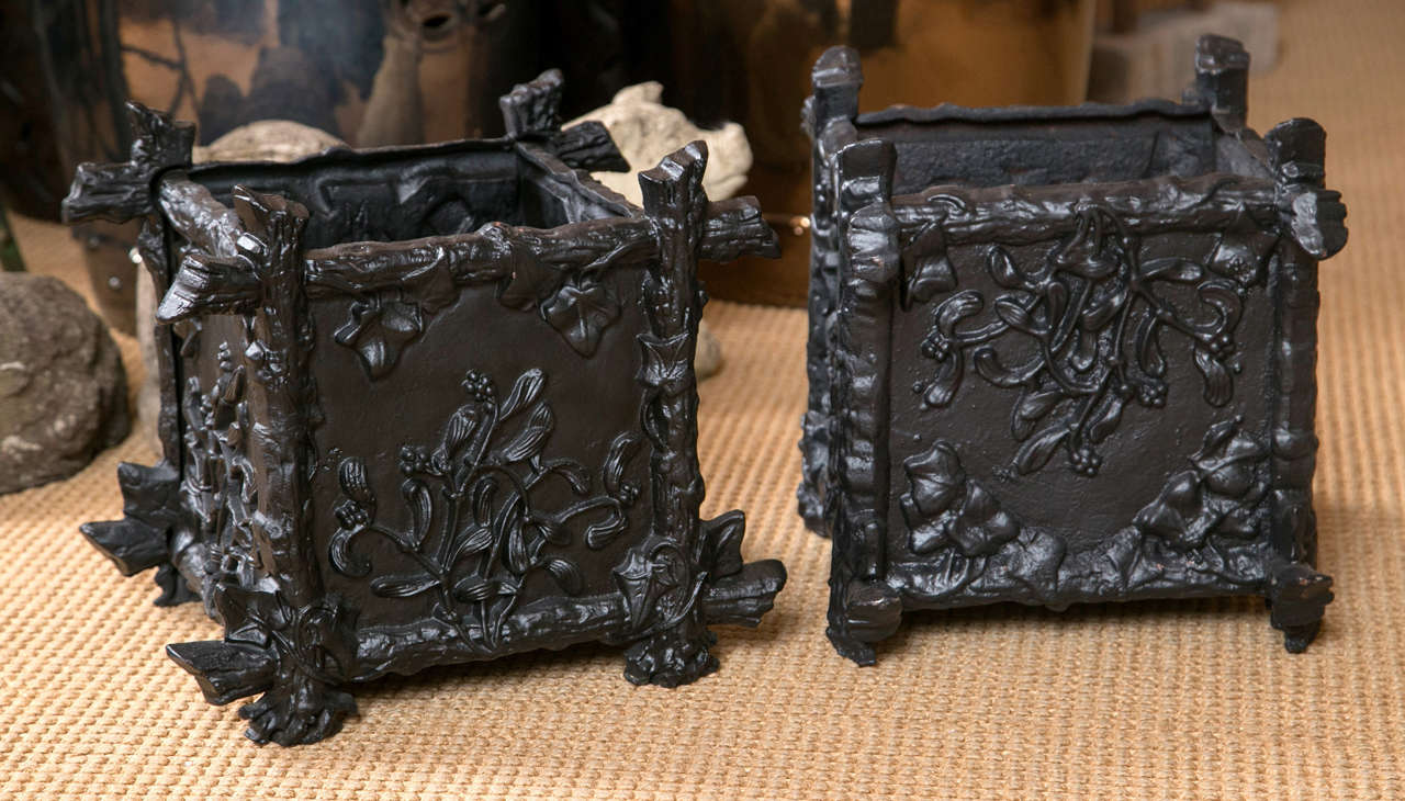 A pair of lovely French black painted cast iron planter boxes with a twig and foliage design.