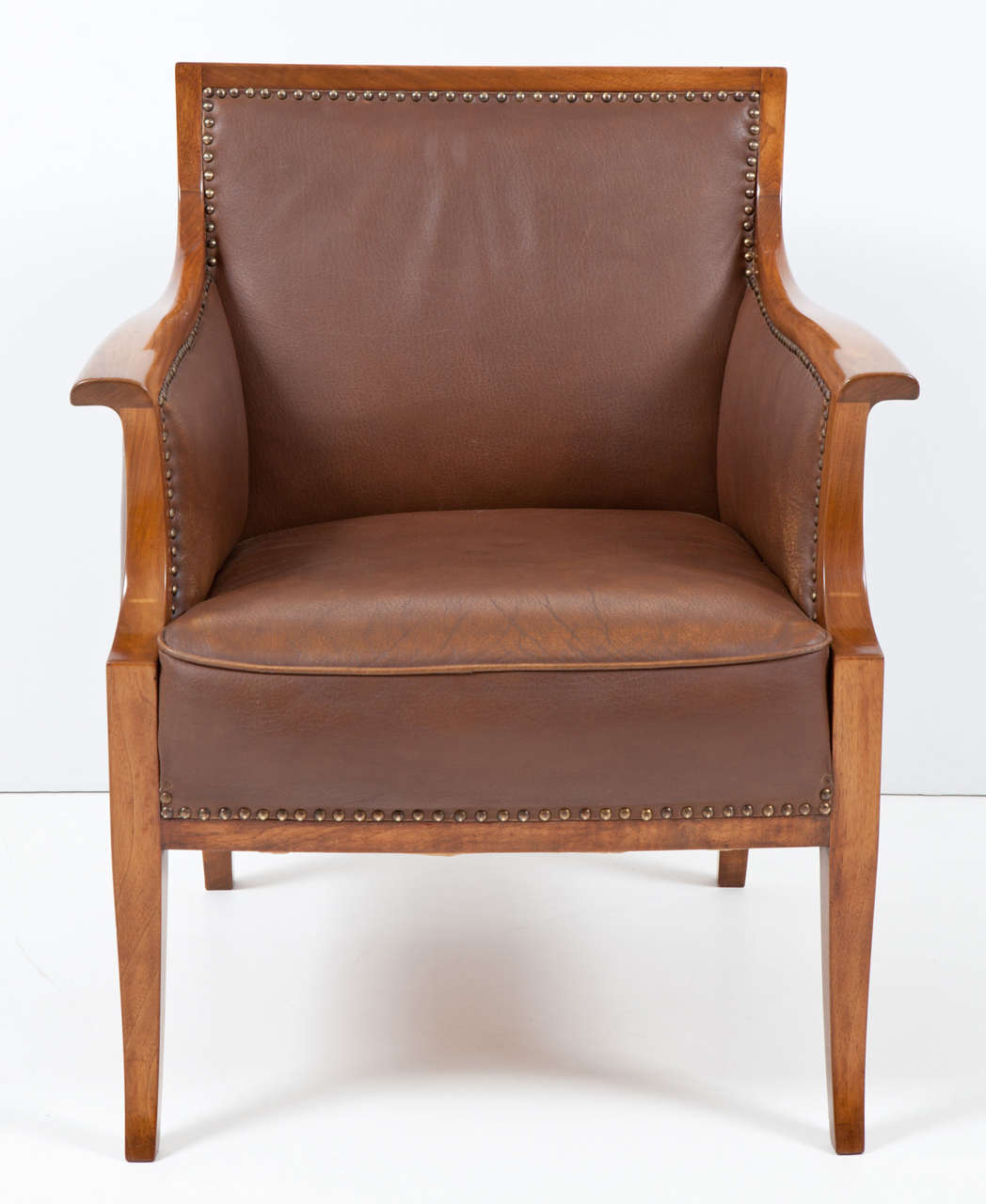 Frits Henningsen walnut armchair with original leather upholstery, circa 1940s, rectangular backrest, tight seat and sabre legs. Good patina to the leather and the frame has been slightly re-polished. Handsome model.