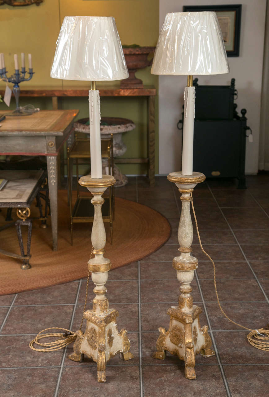 Pair of painted wood floor standing candelabrum.