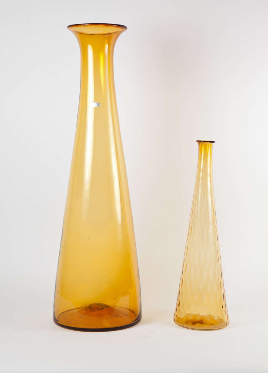 Oversize amber glass vases. Taller vase is by Blenko, USA; shorter vase by Empoli, Italy.  Circa 1950. Available in two sizes; priced individually.