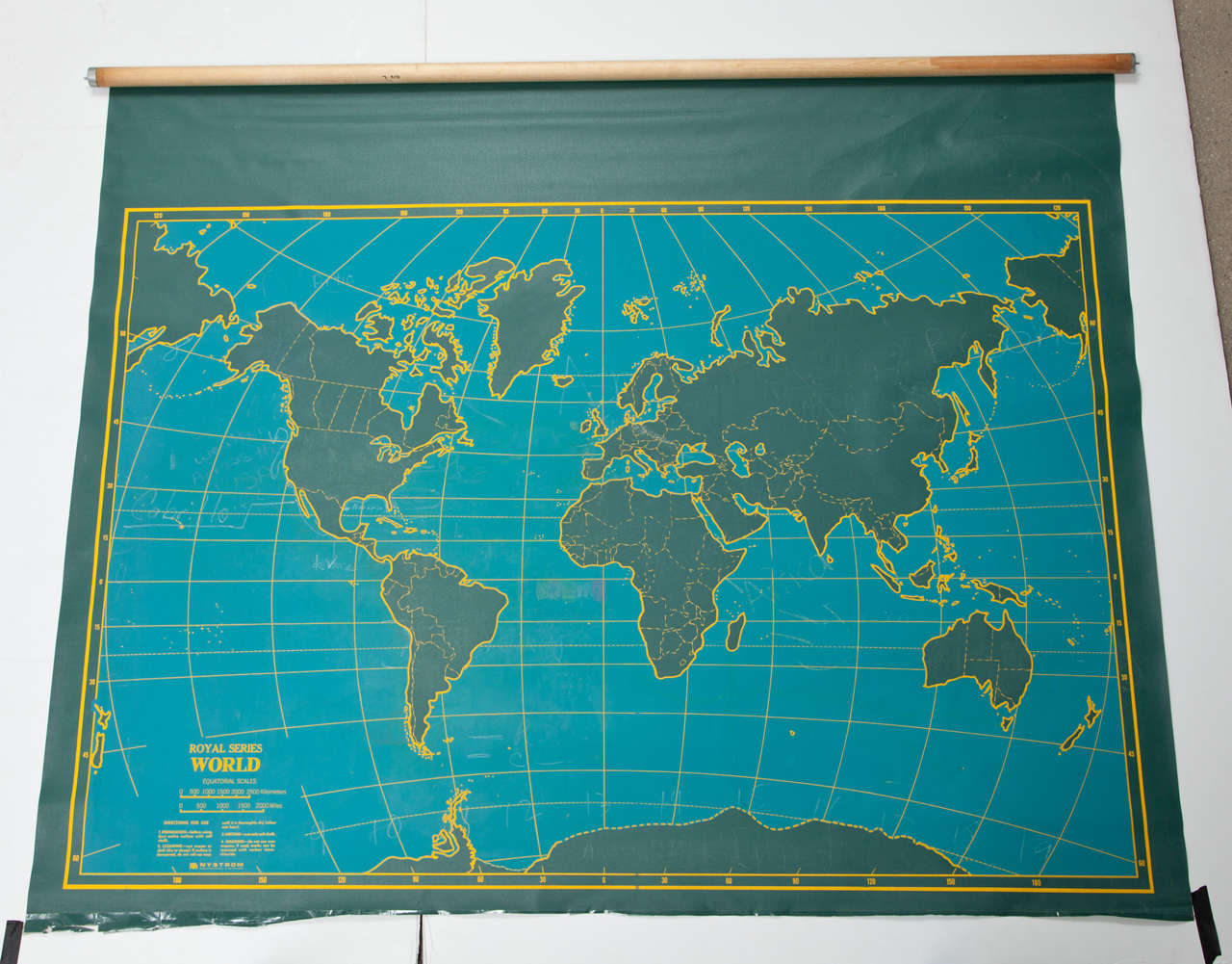 Vintage canvas roll up map by Denoyer Geppart. USA, circa 1950.  Two-sided, with the world map on one side, and the U.S.A on the second side.  Includes original roller mechanism.  Features dark green continents highlighted in gold against a blue sea.