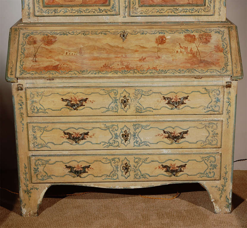 Hand painted Venetian secretary featuring scenes of the Italian countryside and a pale blue interior- the whole on a cream base.
