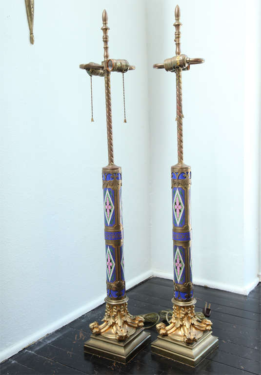 the multi- colored cloisonne columns with bronze overlay resting on finely detailed gilt bronze capitols.