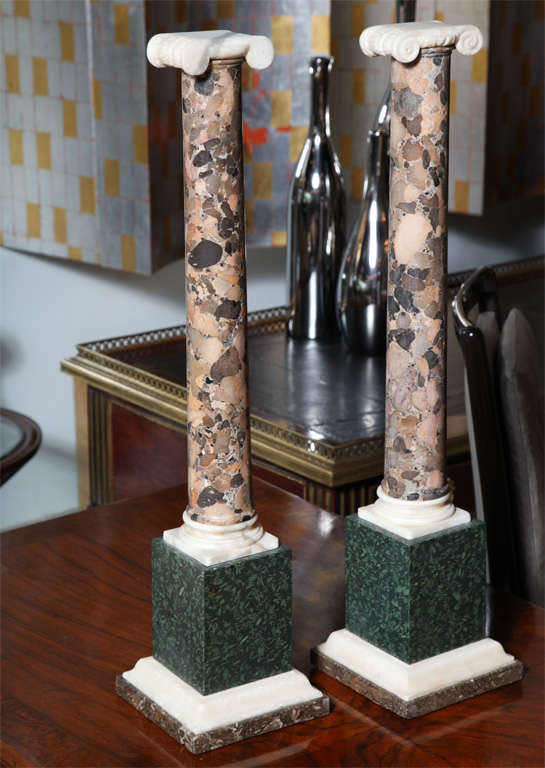 The carved alabster capitols above breche marble columns on porphyry bases.