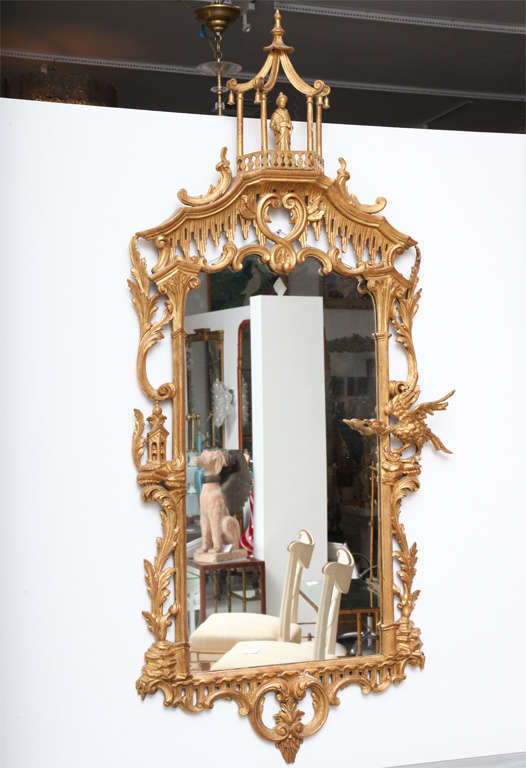 Pair of carved gilt wood mirrors with pagoda motif and male and female Chinoiserie figures.