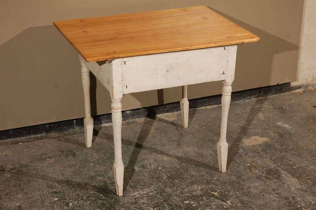 Charming Swedish work table features a natural scrub pine top and spade foot. Rest of the table is finished in gray paint with a  beautifully weathered patina.