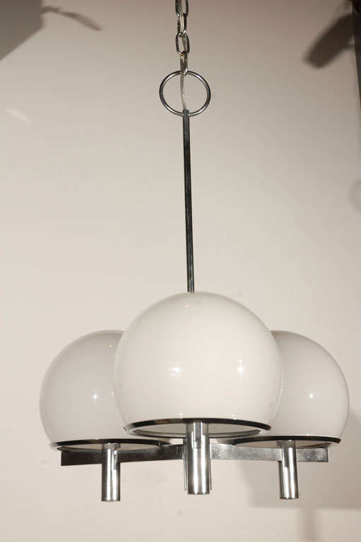 Three white globe Lightolier ceiling fixture. Two ceiling fixtures available. Three pairs of matching sconces available.