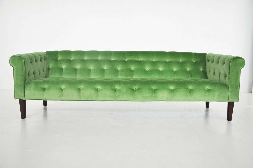 Rare early design by Milo Baughman for Thayer-Coggin.  Chesterfield sofa newly uphosltered in green velvet on newly refinished walnut legs.