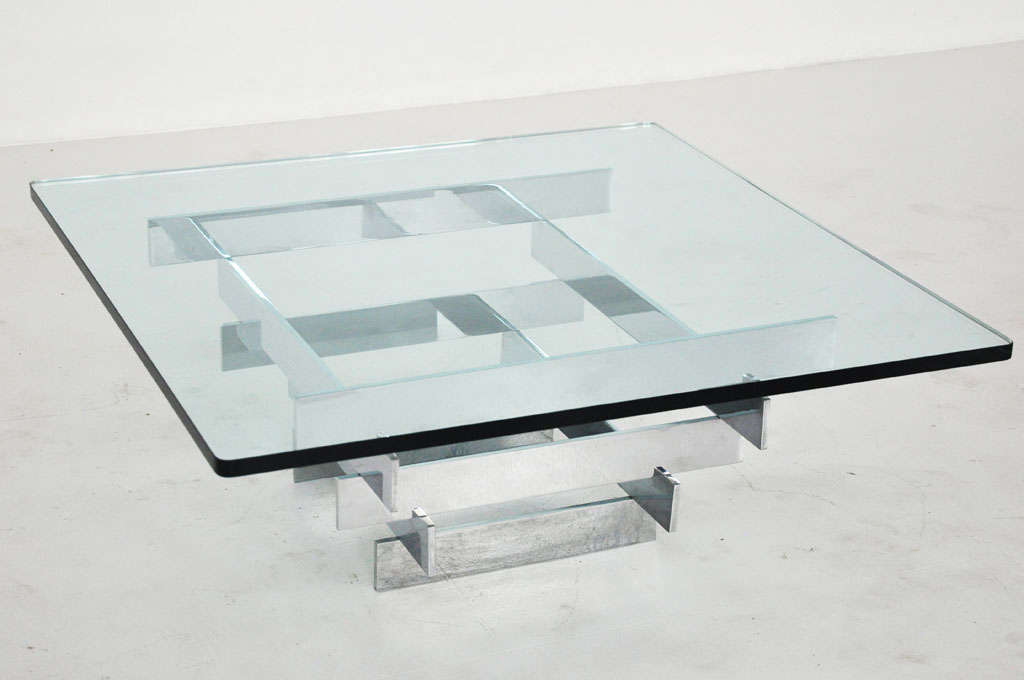 Chrome base coffee table by Paul Mayan for Habitat.  Solid chrome flat bar in pyramid shape with thick plate glass top.