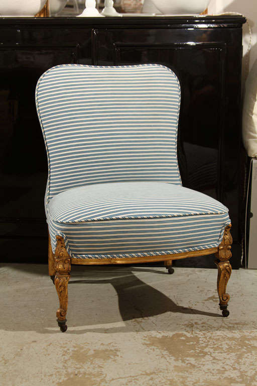 antique chair that has been completely restored... 
original frame and gilt legs and reupholstered using our vintage french ticking.