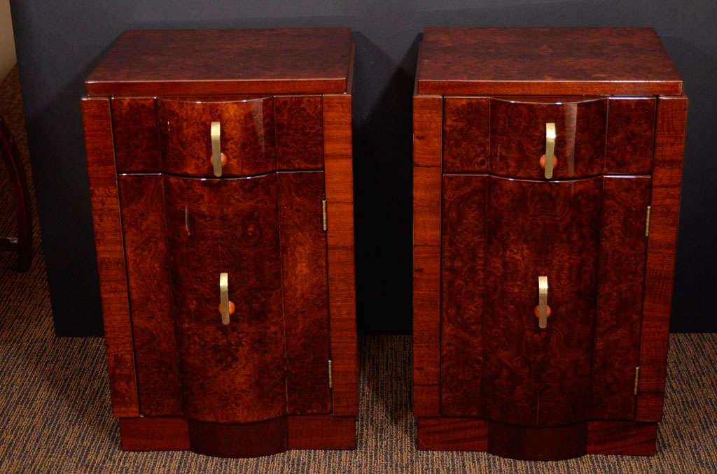 Pair of nightstands in burl and mahogany with bakelite handles.