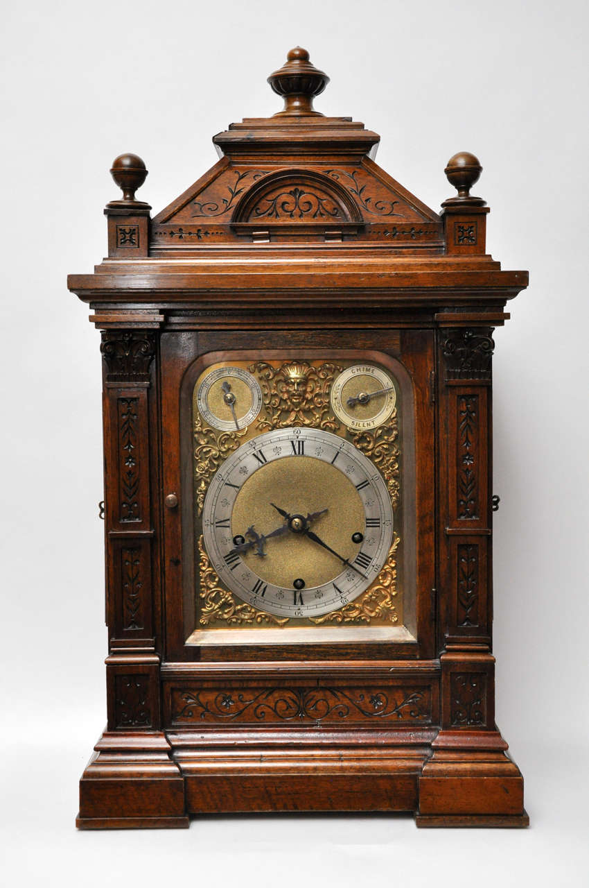 An extraordinary hand carved walnut Westminster, chiming bracket clock, signed on back of movement, W & H Sch. *Winterhalder & Hofmeier of Schwarzenback).  The intricately carved walnut case has a stepped bell shaped crown, a sphere shaped finial on