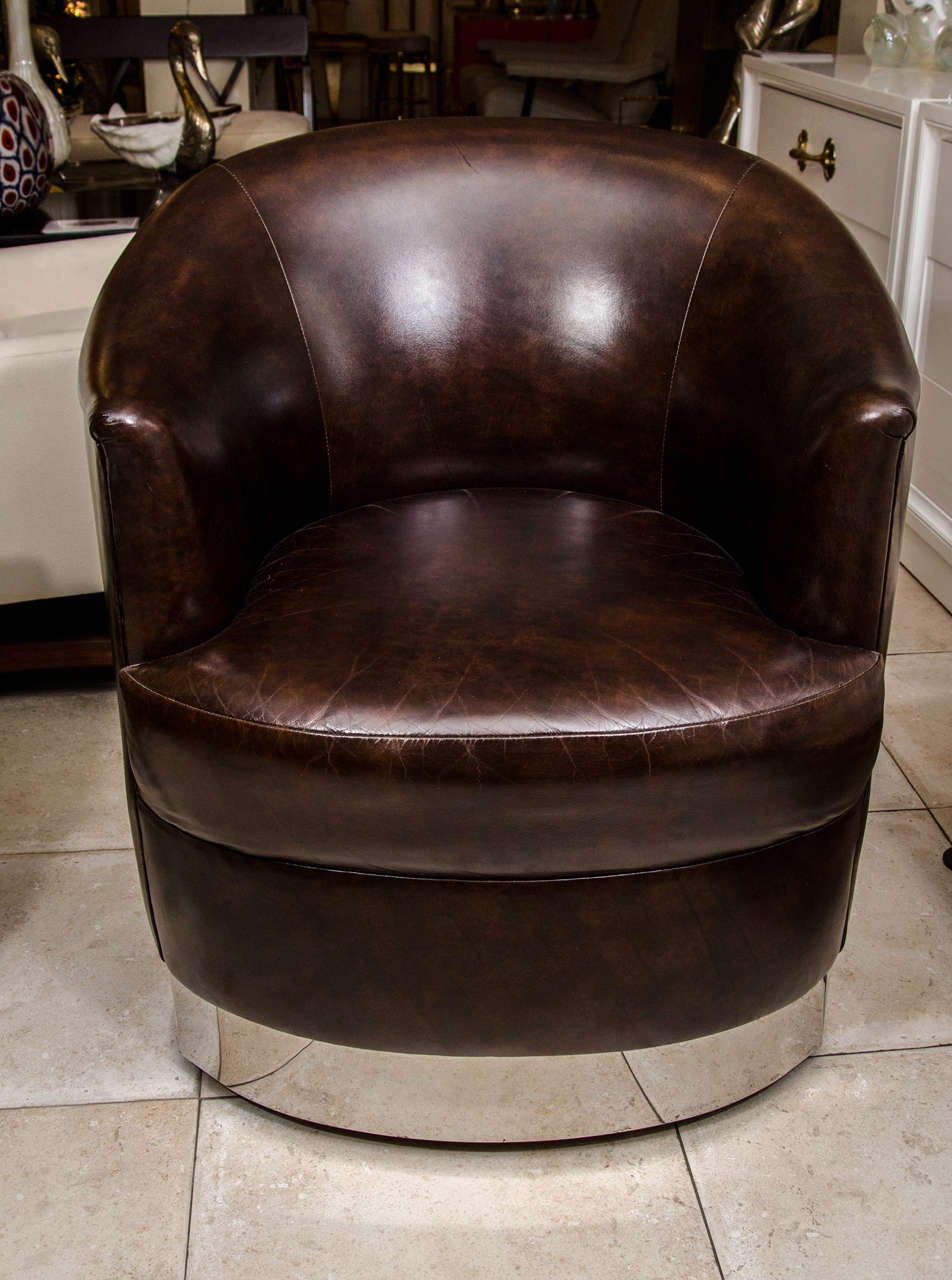 Pair of barrel back leather upholstered swiveling club chairs with chrome detail by Karl Springer.

View our complete collection at www.johnsalibello.com