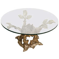 Circular glass top side table with rustic tree form bronze base
