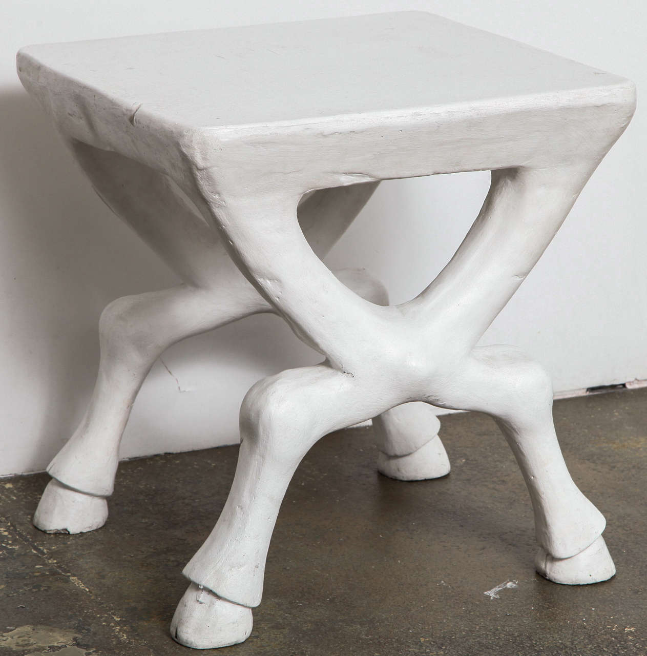 One of the most famous of Dickinson's tables, painted plaster with crossed base form ending in hooves. Made by John Dickinson Studio.