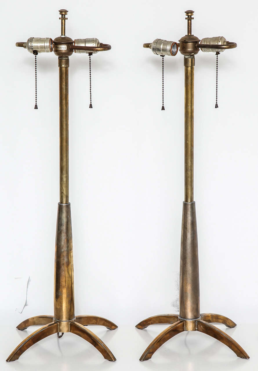 A pair of rocket base lamps designed for Stiffel. The lamps are in original condition with a warm burnished patina.