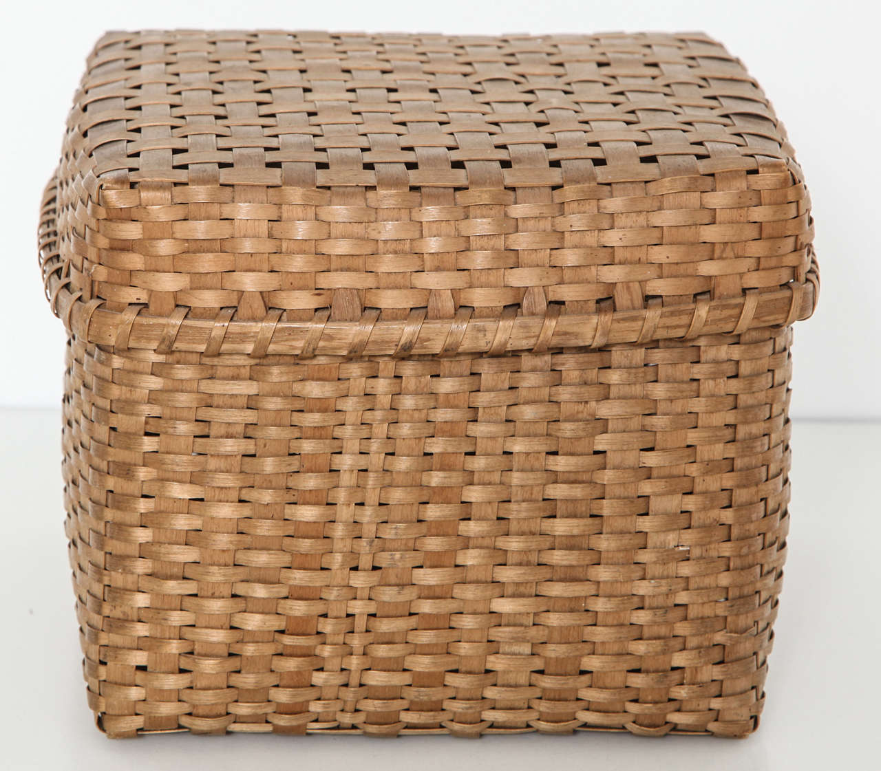 A small square American woven basket with lid from the late 19th century.