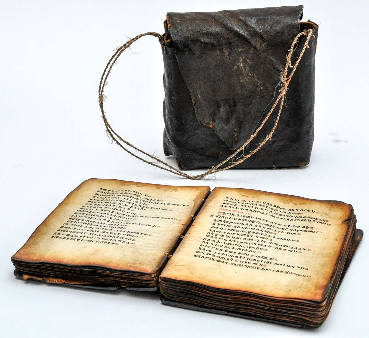 19th century Ethiopian Bible in wood with leather case. This is an exquisite Bible with a handmade leather carrying case. The Bible is bound in a wooden cover, and is written in  the Ge'ez or classical Ethiopic script, a proton-Semitic language. The