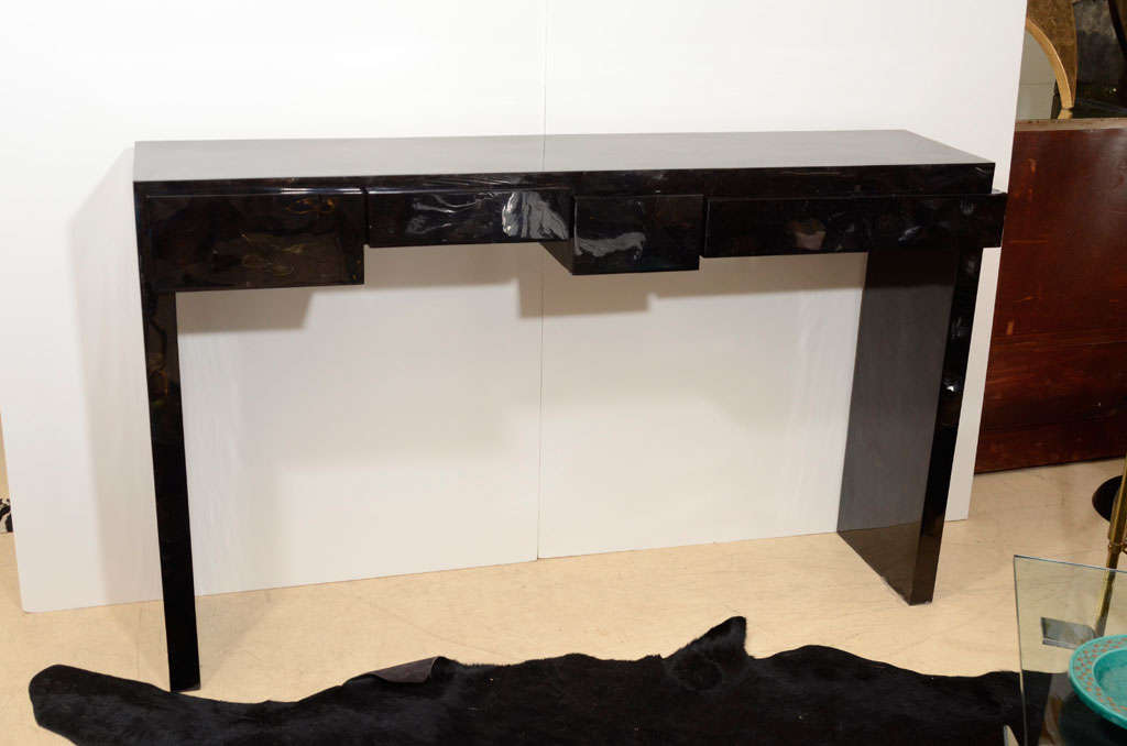 A decorative Art Deco style console made of black sea shell, France, circa 1980. 
The console has four drawers.