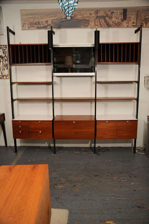 Impressive example of George Nelson's CSS storage system for Herman Miller. The system consists of 6 cabinets and five shelves. The cabinets include a flip down desk surface and an illuminated display cabinet. The cabinets and shelves may be