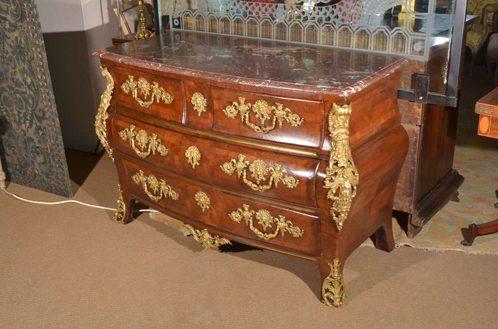 a beautiful period French Regence commode with exquisite gilt bronze mounts, masks / faces and scrolls at sides, masks as escutcheons

male and female busts / upper torsos with heads support large intertwined sea serpent / dolphin pulls, there is
