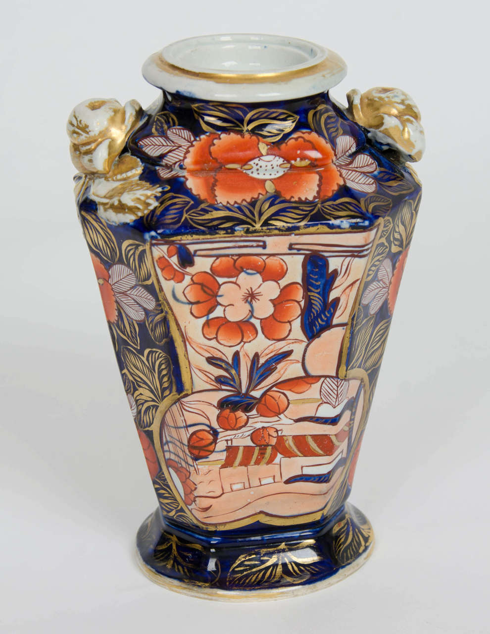 This is a rare ironstone vase, in a very sought after pattern, made by the Mason's factory in the early 19th century.

The vase has a good tapering octagonal profile with two Rose handles at the shoulder. The vase is decorated in the highly