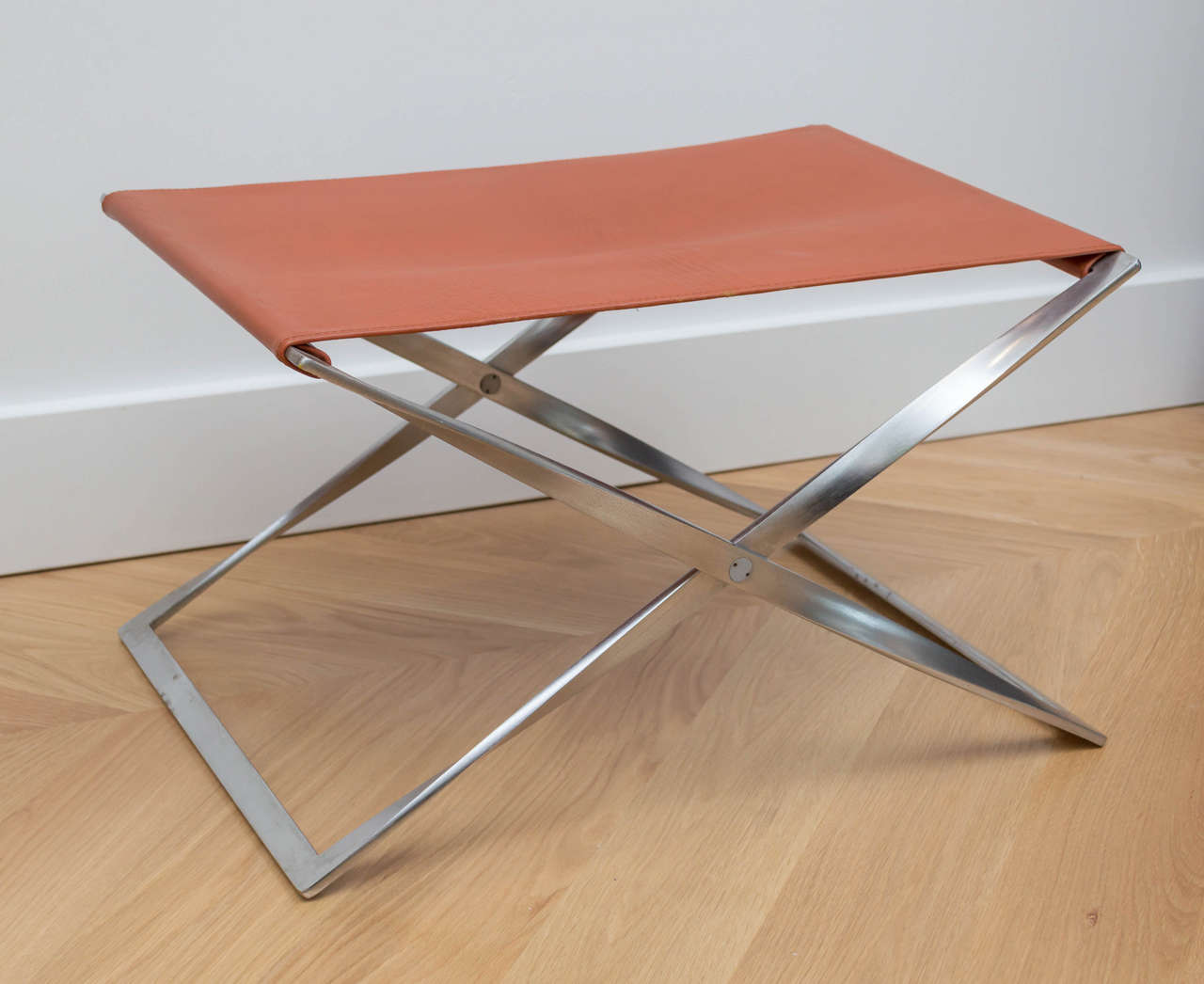 Matte chromed steel folding base with  cognac sling seat. Very good original condition. Made by Fritz Hansen. This example is from 1980s.